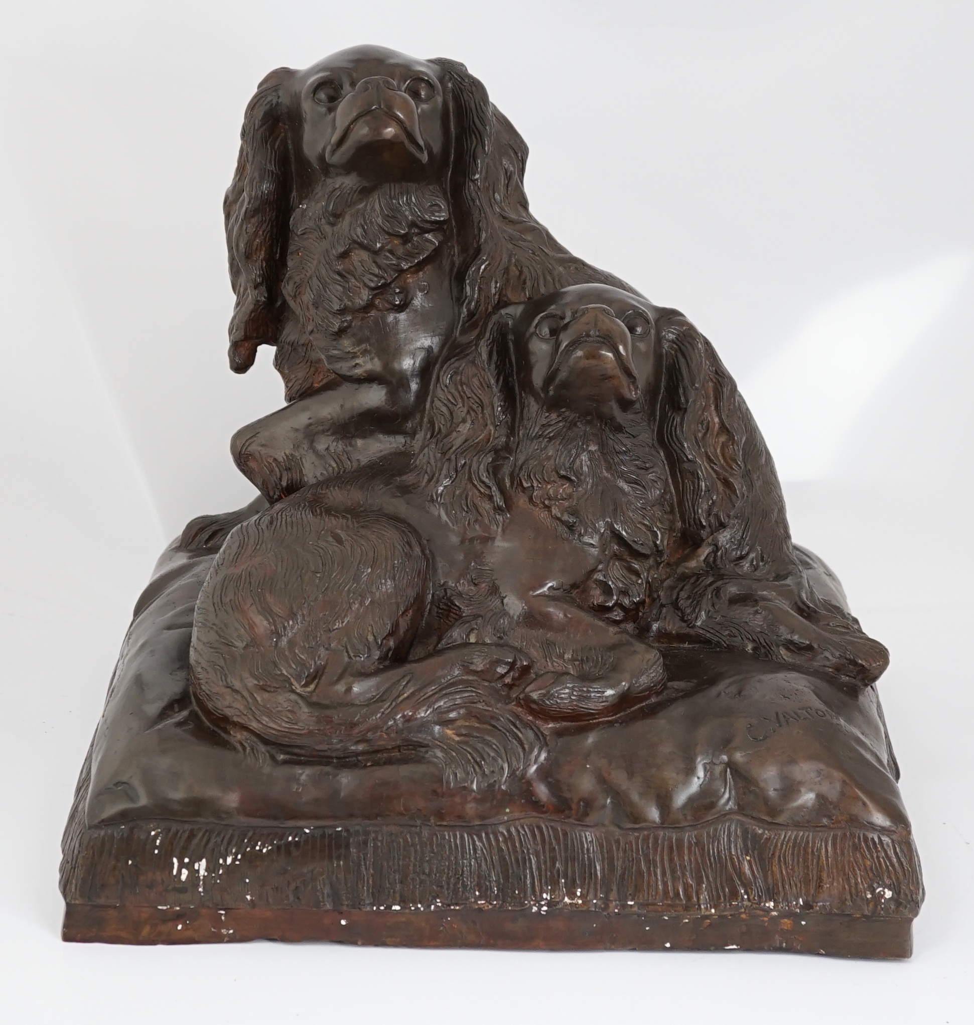 After Charles Valton (French, 1851-1819), a bronze group of two King Charles spaniels seated upon a cushion, 46cm wide, 42cm high